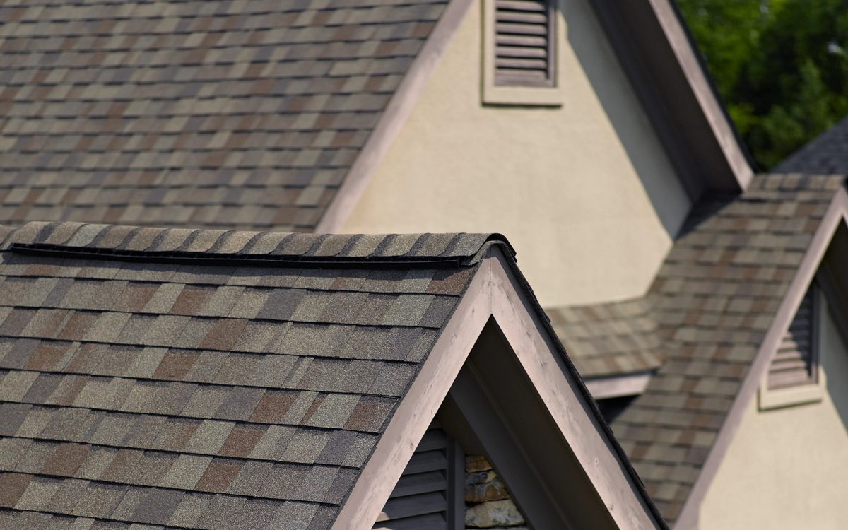 Close-up of CertainTeed Landmark shingles along the roof ridge beside a gable vent