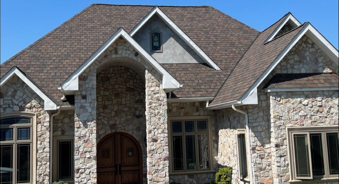 Completed CertainTeed architectural shingle roof on a stone-front home in Chester County